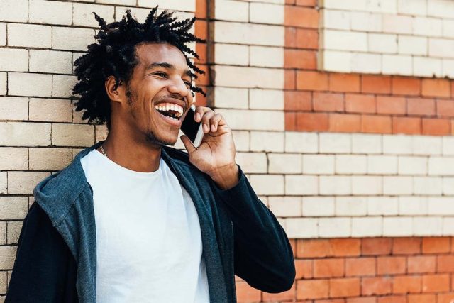 patient smiling brightly after customized CEREC dental crown treatment